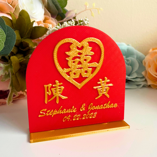 Red and gold 3D printed table number holder with custom names in English and Chinese characters