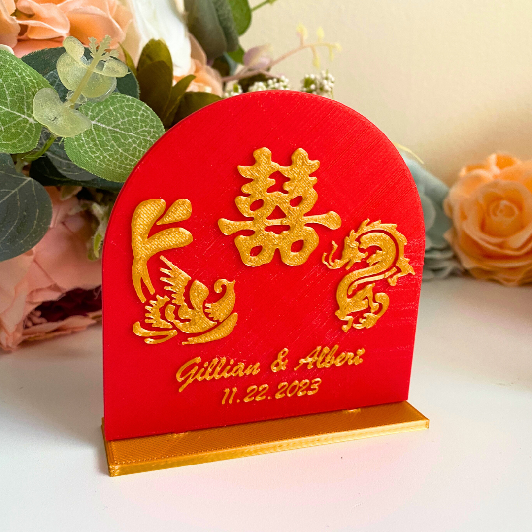 Red and gold Chinese wedding table number holders with double happiness symbol and names