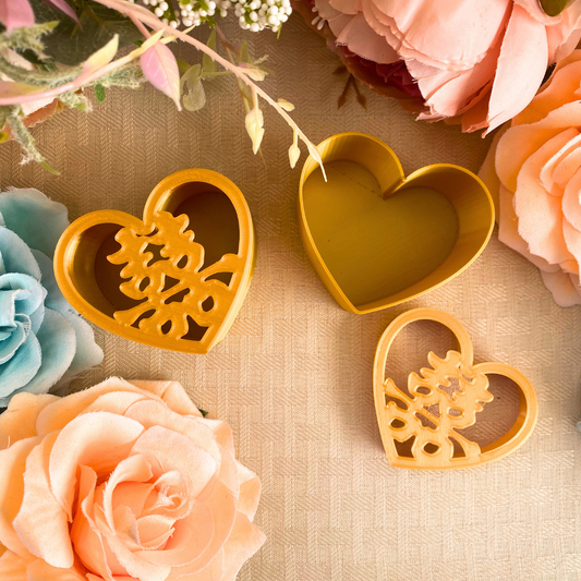 Gold 3D printed heart-shaped wedding favor boxes with the double happiness symbol on the lid