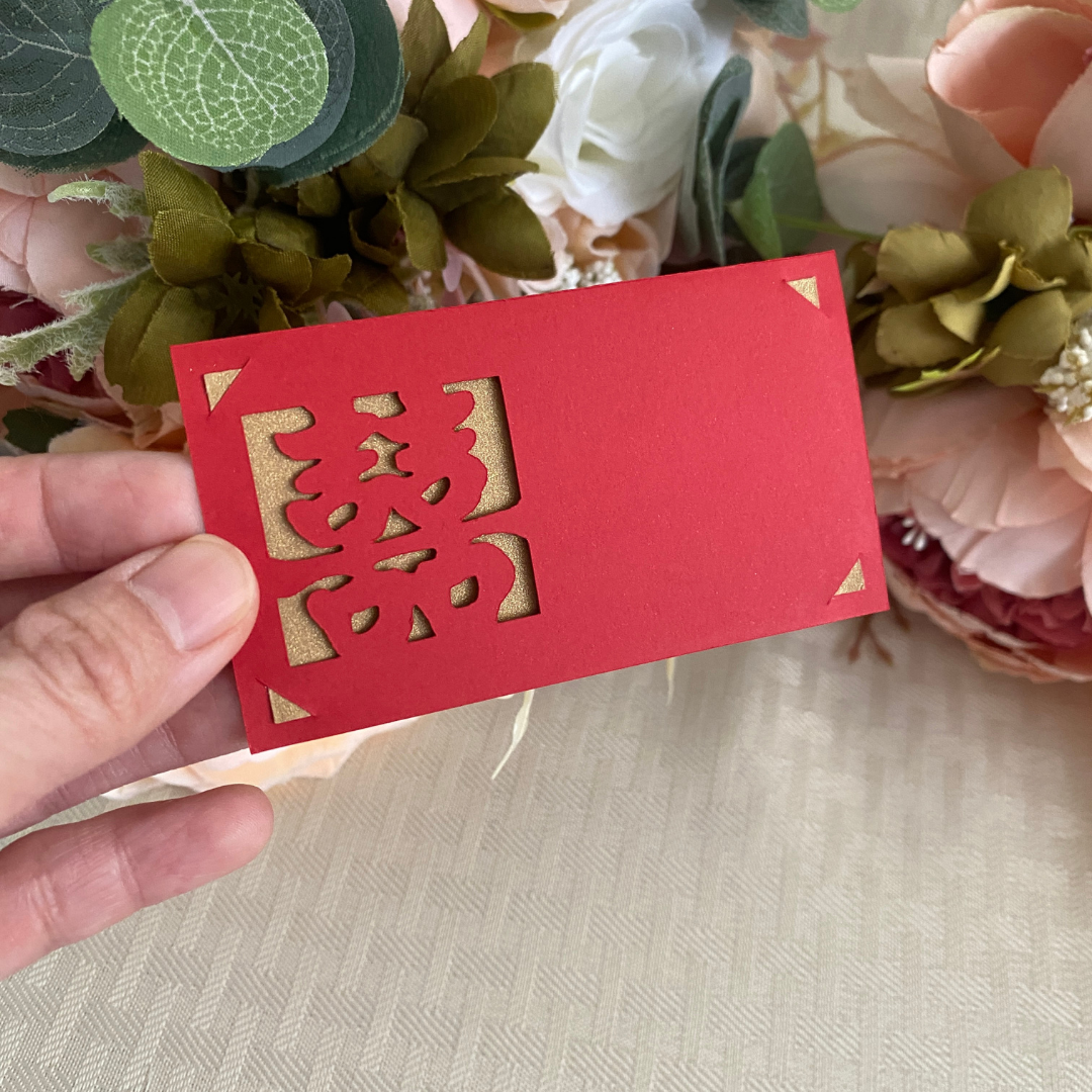 Red Chinese wedding place cards with double happiness symbol and gold backing